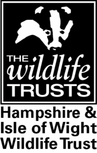 Hampshire & Isle of Wight Wildlife Trust logo with badger silhouette and text The Wildlife Trusts
