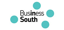 Business South text logo with five teal dots around the words